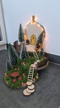 a miniature garden with steps leading to a fairy house