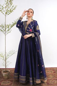 A royal blue frock in raw silk with embroidery on the bodice and a matching net dupatta with kiran along its width. Finished with a jamawar trouser for a regal touch.3-piece suitReady to wear Designer Raw Silk Dress With Dabka Details, Designer Raw Silk Dabka Dress, Blue Jamawar Wedding Dress, Anarkali Sets With Resham Embroidery In Raw Silk, Elegant Blue Raw Silk Lawn Suit, Blue Jamawar Lawn Suit With Intricate Embroidery, Eid Gown With Jamawar Fabric And Traditional Drape, Traditional Jamawar Gown For Eid, Festive Jamawar Gown With Dabka Work