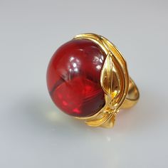 Amber ring. Ruby red Amber ring. Gold plated handmade ring. This ring is adjustable. You can change size by pressing it. Very easy to do. Stunning red ring will be just the best gift for her. Gemstone size 2,6-2,7 cm. Weight 13,79 gr. Big round - circle ring. This item was made of natural Baltic Amber. All the amber used in my jewelry is collected in my home country Lithuania. I sell only genuine, real, Baltic Amber. This is a yellow amber stone processed and paintedto make it look ruby red. Luxury Amber Rings As Gifts, Luxury Amber Ring As Gift, Elegant Red Dome Ring For Formal Occasions, Elegant Amber Rings For Gifts, Elegant Red Dome Ring For Anniversary, Luxury Amber Rings For Gift, Elegant Red Ruby Ring For Jewelry Making, Formal Amber Open Ring Jewelry, Elegant Handmade Red Rings