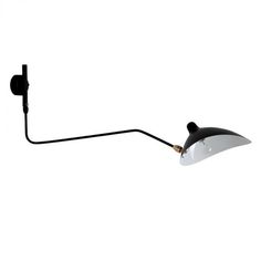 a black and white wall light with a cord attached to the back of it's arm