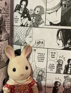 a stuffed animal is sitting in front of a comic strip with anime characters on it