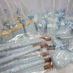 blue and white cake pops are wrapped in plastic