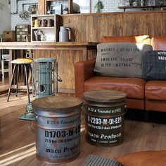 a living room filled with furniture next to a wooden table and brown leather couches