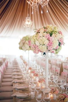 an image of a table setting with flowers and candles on the tables in front of them