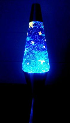 a blue lamp with stars on it in the dark