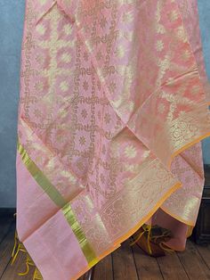 Stunning Banarasi Dupatta in Pastel Pink or Baby Pink Color with Muted Zari Weaving. Floral Design in Jaal with tassles. Give your Outfit a new look with these beauties. ❤️ Please note dupatta has yellow color tassels at the ends. Item: DupattaBase color : Pastel Baby Pink Fabric : Soft Semi Silk (Not Pure Silk)Work : Zari Weaved with tasselsLength of the Dupatta : 92 inches approx.Width of the dupatta : 35 inches (Approx.) Store Policies- No return or exchange will be accepted for color variations.- No return or exchange will be accepted if the color does not match your other clothing or your partners or anyone else.- Since this Dupatta is handmade hence little inconsistencies may be there however it is not considered as a defect.- Zari or thread coming out or on folds is not considered a Chanderi Dupatta With Self Design For Celebration, Celebration Dupatta With Self Design In Chanderi, Eid Celebration Dupatta With Zari Weaving, Eid Celebration Zari Weaving Dupatta, Celebration Dupatta With Traditional Drape And Self Design, Silk Thread Traditional Wear For Diwali Puja, Handloom Jamawar Traditional Wear For Celebration, Orange Handloom Dupatta For Wedding, Handloom Dupatta For Celebration With Traditional Drape