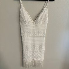 a white dress hanging on a wall