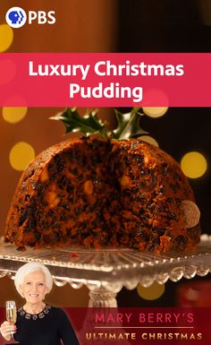 a woman standing in front of a cake on top of a glass platter with the words luxury christmas pudding