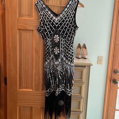 Perfect For A 1920s Party. Black And Silver Sequin Dress With Flapper Fringe. Beautiful And Never Worn. Nwt Black 1920s Flapper Dress For Costume Party, Black Art Deco Dress For Costume Party, Art Deco Flapper Dress For Evening Parties, Black Flapper Dress For Party, Black Flapper Dress For Cocktail Events, Black Cocktail Flapper Dress, Black Sequined Art Deco Flapper Dress, 1920s Black Flapper Dress For Cocktail, Black Art Deco Flapper Dress With Sequins