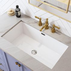 a bathroom sink with two faucets on the side and a mirror above it