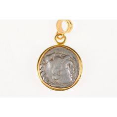 This is part of Chairish’s Fine Jewelry assortment.  An authentic Greek, Alexander the Great, AR Drachm coin (circa 3rd century BC), set in a round 22k gold bezel with 22k gold bail. The obverse, or front side of this coin features the head of Herakles wearing a lion skin headdress. On the reverse side, Zeus seated, holding an eagle and sceptre. This coin has been inspected and approved to be authentic by a professional Numismatic who specializes in ancient coinage. A Certificate of Authenticity Ancient Yellow Gold Coin Pendant Jewelry, Byzantine Coin Pendant Jewelry, Byzantine Yellow Gold Medallion Coin Necklace, Byzantine Style Yellow Gold Medallion Coin Necklace, Byzantine Yellow Gold Coin-shaped Jewelry, Byzantine Style Coin-shaped Yellow Gold Jewelry, Byzantine Round Coin Pendant Jewelry, Byzantine Style Yellow Gold Coin Jewelry, Byzantine Style Coin Shaped Yellow Gold Jewelry