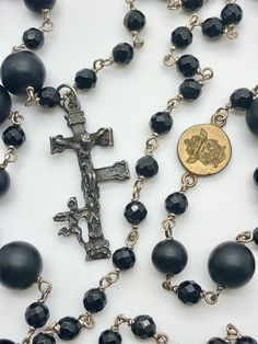 17th Century Spanish Antique Caravaca Crucifix Icon. Presented on a rosary inspired hand crafted solid sterling silver chain with genuine faceted black onyx beads and genuine round matte black onyx beads. ♛ 17th Century Spanish Antique Caravaca Crucifix icon ♛ Hand crafted Solid Sterling Silver Link Chain ♛ 4 mm Genuine Faceted Black Onyx Beads ♛ 6mm Genuine Round Matte Black Onyx Beads ♛ 8mm Genuine Round Matte Black Onyx Beads ♛ 42 inches long ♛ La Magdala signature brass charm insignia Every Elegant Black Crucifix Jewelry, Black Beads With Victorian Pendant, Black Beaded Crucifix Jewelry, Vintage Black Cross Necklace, Elegant Black Onyx Beads, Mens Cross Necklace, Silver Link Chain, Black Onyx Bracelet, Edwardian Jewelry