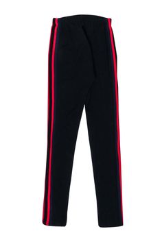 Add sleek street style to your wardrobe with the Yeezy Season 5 football leggings. Soft and smooth stretch fabric hugs your figure for the perfect fit, while striking side stripes in navy and red add a sporty touch. Finished with a playful lace-up front, these statement leggings pair perfectly with white sneakers and a classic tee for a fresh weekend fit. Size XS 100% Nylon Elasticized waist w/ lace-up closure Contrast striping along sides Waist (unstretched) 22" Inseam 28.5" Length 36.5" Black Streetwear Leggings, Black Elastane Leggings For Streetwear, Sporty Red Activewear With Three Stripes, Sporty Red Three Stripes Activewear, Red Sporty Activewear With Three Stripes, Red Three Stripes Sporty Activewear, Streetwear Athleisure Leggings, Athleisure Elastane Leggings For Streetwear, Sporty Fitted Leggings For Streetwear