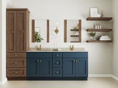 a bathroom with two sinks and wooden cabinets