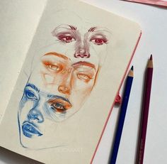 a pencil drawing of two women's faces on a notebook with colored pencils