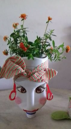 a vase with flowers in it sitting on a table next to a stuffed animal toy