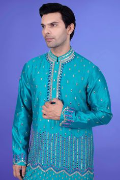 Enhance your style with our Mens Kurta Pajama J171-N217. This premium piece features intricate mirror and thread work, elevating the look to a whole new level. Perfect for special occasions or elevating your everyday style. Experience luxury and elegance in every wear. Blue Naqshi Unstitched Suit For Diwali, Blue Traditional Wear With Naqshi, Blue Cutdana Kurta For Ceremonial Occasions, Blue Bollywood Style Ceremonial Kurta, Traditional Blue Kurta With Naqshi, Traditional Blue Salwar Kameez With Naqshi, Turquoise Kurta With Zari Work For Festive Occasions, Traditional Turquoise Kurta With Zari Work, Blue Unstitched Suit With Naqshi For Festivals