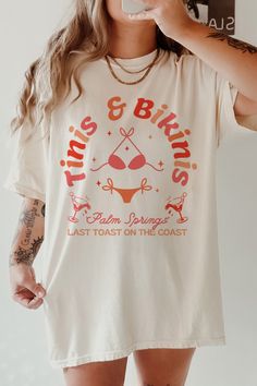 a woman taking a selfie while wearing a white t - shirt with the words true & bikinis written on it