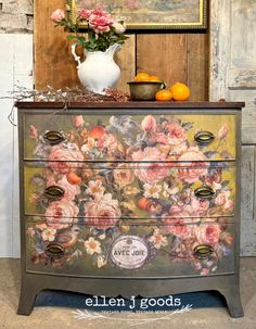 an old dresser painted with flowers and fruit