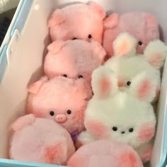 a group of stuffed animals in a blue container