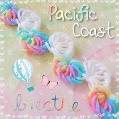 there are some colorful bracelets that say breathe and have balloons attached to the strings