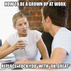 a woman is talking to a man in front of a computer and holding a cup