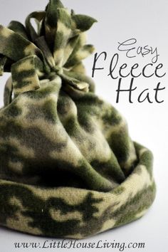 an easy fleece hat with a bow on the front and side, made from green camo fabric