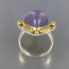 "A gorgeous rich lavender color with swirling patterns in reddish purple, I've set this incredible high-domed gem quality Lavender Jade cabochon (which I cut) in an 18kt gold bezel with accent orbs of 18kt gold upon a sterling silver base. The richness of the 18kt Gold and the color of the Lavender Jade make this a real attention stealing \"Statement\" ring. The character and color of this Lavender Jade from Turkey have made it one of my favorites with which to work and always draws great attent Purple Jewelry Ring With Large Stone, Purple Round Large Stone Jewelry, Purple Jade Jewelry, Lavender Jade Ring, Vintage Jade Cabochon Ring, Lavender Color, Swirl Pattern, Jade, Heart Ring