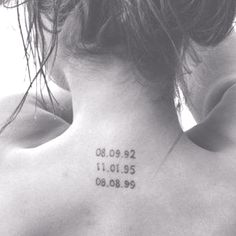 the back of a woman's neck with numbers on it