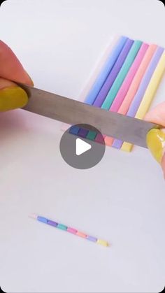 someone cutting colored pencils with a large knife