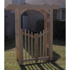 a wooden gate in front of a house