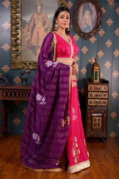 Rani pink lehenga with foil printed floral motifs and gota patti border. Comes with V neck blouse with lace trim and purple dupatta.
Component: 3
Pattern: Print and Embroidery
Type Of Work: Foil Print, Gota Patti and Sequin
Neckline: V neck
Sleeve Type: Half
Fabric: Cotton Silk
Color: Pink
Other Details: 
Purple dupatta with floral motifs and lace trim border
Sequin embroidered waistband
Tie up with tassels on the sides
Occasion: Sangeet - Aza Fashions Pink Raw Silk Pre-draped Saree With Dupatta, Festive Pink Raw Silk Pre-draped Saree, Designer Pink Pre-draped Saree With Zari Work, Pink Raw Silk Set With Zari Work, Pink Raw Silk Saree With Gota Work, Pink Dola Silk Sets With Gota Work, Pink Traditional Wear With Gota Work In Raw Silk, Pink Pre-draped Saree With Gota Work, Pink Dola Silk Choli With Zari Work