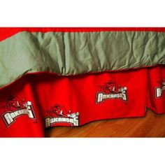 a red bed skirt with the university of wisconsin logo on it