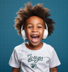 a young boy wearing headphones and smiling at the camera with his mouth wide open