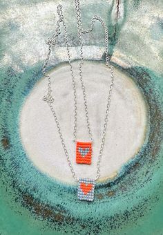 two orange and white squares on a chain