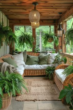 a covered porch with wicker furniture and potted plants