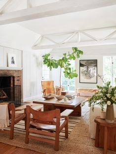 a living room filled with furniture and a fire place next to a wooden coffee table