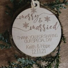 a wooden ornament hanging from a tree with the words merry and married on it