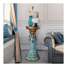 a blue and green vase sitting on top of a table next to a couch