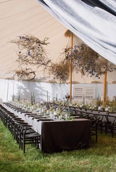 an outdoor tent with tables and chairs set up