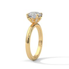 a yellow gold engagement ring with a pear shaped diamond