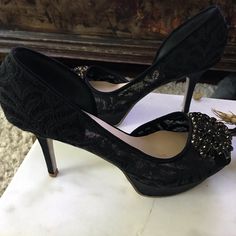 These Are Beautiful Platform Pumps. The Shoe Is Black Lace With Black Satin 4” Heel And Platform. The Front Is Embellished With Black Stones Set In Gold. These Were Never Worn As You Can See On Bottoms, But Were The Floor Sample So Some Worn Areas On Inside Of Shoe As Pictured. The Insoles Have Padding. I Believe They Run Slightly Large Nine West Shoes, Platform Pumps, Black Stone, Black Satin, Nine West, Stone Settings, Black Lace, Satin, Pumps