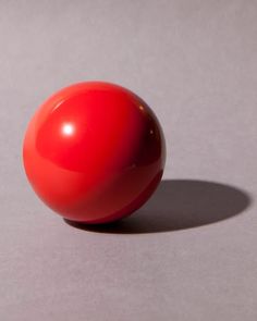 a red ball sitting on top of a table