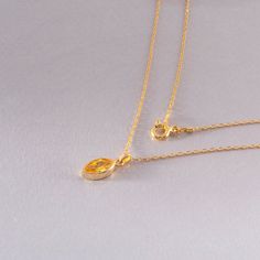 Illuminate your style with our stunning Bezel Marquise Cut Yellow Topaz Necklace, a dazzling piece of minimalist jewelry that captures the essence of sunshine. This exquisite necklace showcases a brilliant marquise-cut yellow topaz, known for its warm, golden hue, perfectly cradled in a sleek 14K solid gold bezel setting. It's the epitome of understated luxury and modern elegance. Why This Yellow Topaz Necklace Shines: 1. Captivating Color: The yellow topaz radiates a warm, golden glow, reminisc Topaz Jewelry Yellow, Yellow Topaz Ring, Topaz Jewelry, Topaz Necklace, Golden Glow, Minimalist Chic, Birthstone Pendant, Marquise Cut, Topaz Ring