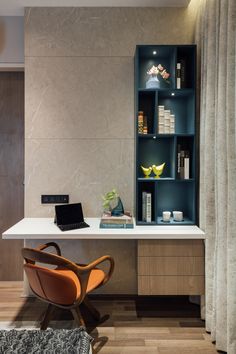 a desk with a laptop on it next to a book shelf