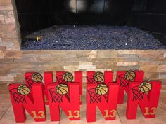 three wooden blocks with basketballs on them in front of a fireplace