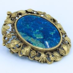 "Beautiful floral detailing in this vintage convertible brooch / pendant. Beautifully crafted 10k Gold setting with large polished lapis cabochon. Fold away bale. This piece has no markings. Chain not included - Need one? Just ask, we can help. Length of Brooch 1.80\" Length of pendant including bale 2.0\" Width of Brooch 1.54\" Lapis measurements 29.5x23 mm Weight of piece 0.48 Oz (13.62 g) CHAIN NOT INCLUDED - FOR DISPLAY ONLY This item is vintage. It has been cherished, worn, and preserved by Antique Oval Gemstone Brooch, Antique Oval Gemstone Brooches, Vintage Gemstone Brooches For Formal Occasions, Ornate Gemstone Brooches For Collectors, Vintage Hallmarked Pendant Brooches, Art Nouveau Filigree Brooch For Collectors, Collectible Art Nouveau Filigree Brooches, Antique Pendant Brooches With Gemstone, Oval Brooch For Vintage Events