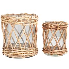 two wicker candle holders with glass lids on white background, one is empty and the other has no candles in it