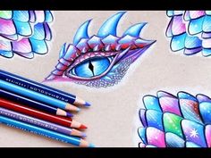 some colored pencils are next to an image of a dragon's eye and wings