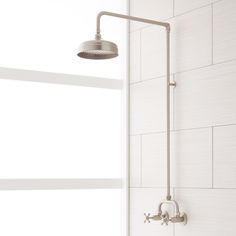 a shower head and arm in a bathroom